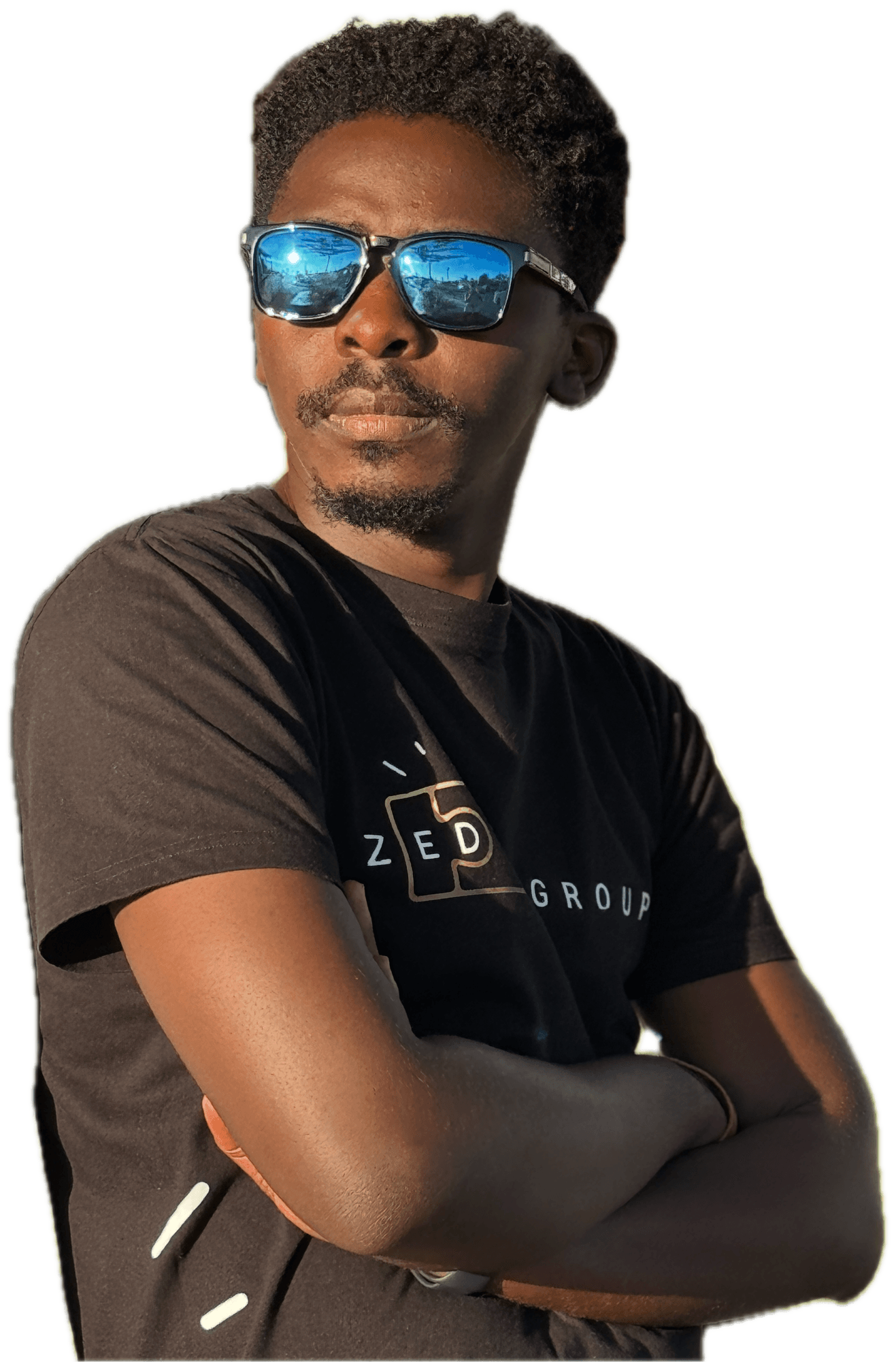 Dan Baruka, arms crossed, wearing sunglasses